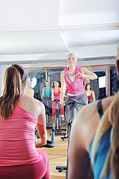 Beautiful woman doing exercise in a spinning class