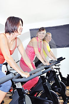 Beautiful woman doing exercise in a spinning class