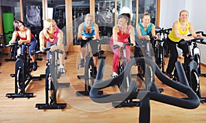 Beautiful woman doing exercise in a spinning class
