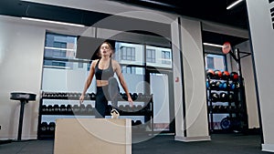 Beautiful woman doing jumping in gym.