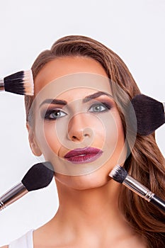 Beautiful woman doing make-up on face