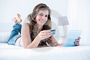 Beautiful woman doing online shopping with her tablet pc