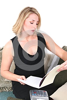 Beautiful Woman Doing Taxes or Budgeting at Home