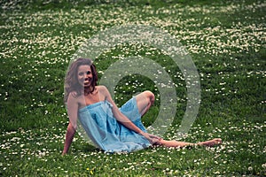 Beautiful woman doing yoga on meadow