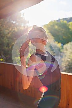 Beautiful woman doing yoga in the morning park. The concept of a healthy lifestyle outdoors. Sport. Nature portrait woman doing