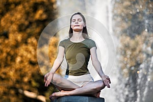 Beautiful woman doing yoga pose in the city park and enjoy healthy lifestyle