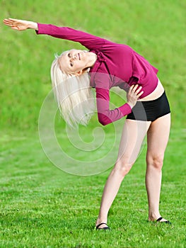 Beautiful woman doing yoga stretching exercise