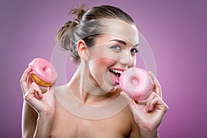 Beautiful woman with donuts. You may eat or not?