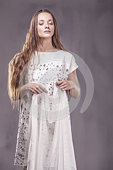 Beautiful woman in dress elegantem in the Studio