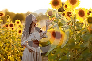 Beautiful woman in a dress in a field of sunflowers