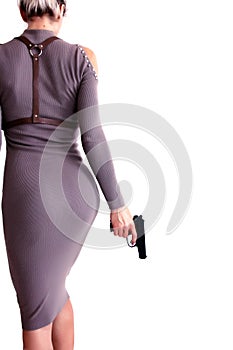 Beautiful woman in a dress holding a gun in her hand