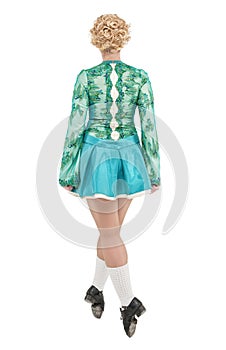 Beautiful woman in dress for Irish dance back pose isolated