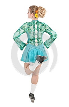 Beautiful woman in dress for Irish dance back pose isolated