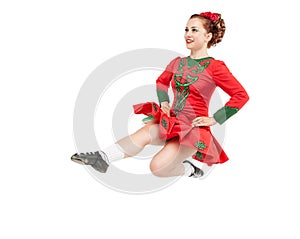 Beautiful woman in dress for Irish dance jumping isolated