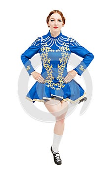 Beautiful woman in dress for Irish dance jumping isolated