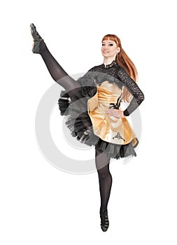 Beautiful woman in dress for Irish dance with leg up isolated