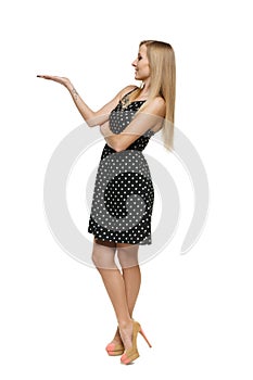 Beautiful woman in dress showing empty copy space on her palm