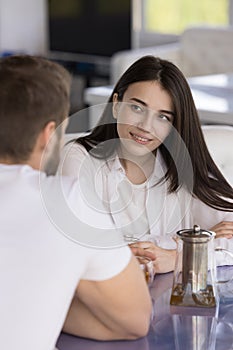 Beautiful woman drink tea, enjoy talk with boyfriend in cafe