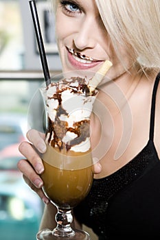 Beautiful woman drinking a glass of iced coffee