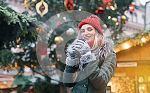 Beautiful woman drinking mulled wine on Christmas market