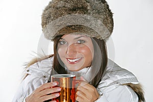 Beautiful woman drinking warm beverage