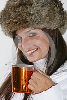 Beautiful woman drinking warm beverage photo