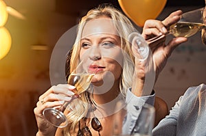 Beautiful woman drinking wine at party