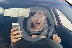 Beautiful woman driving car while texting using mobile phone distracted photo