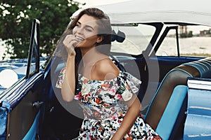 Beautiful woman driving a retro convertible car