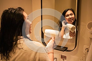 A beautiful woman is drying her hair