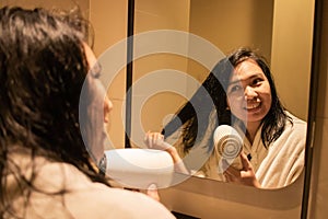 A beautiful woman is drying her hair