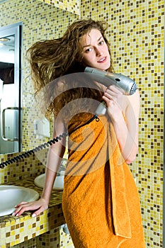 Beautiful woman drying her hair