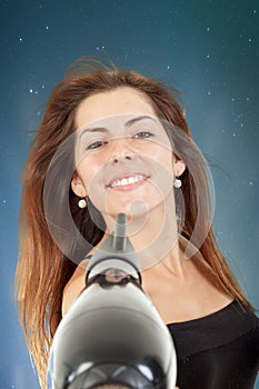 Beautiful woman drying her hair with hairdryer