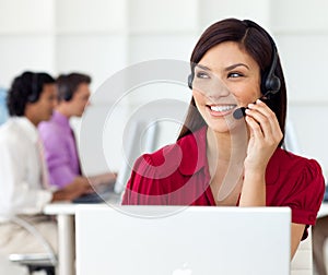 Beautiful woman with earpiece on in a call centre