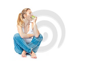 Beautiful woman is eating apple on white background. Healthy lifestyle and diet concept.