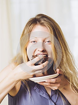 Beautiful woman eating a brownie