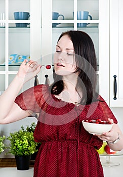 Beautiful woman eating cherry