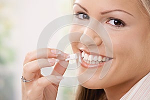 Beautiful woman eating chewing gum photo