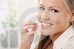 Beautiful woman eating chewing gum