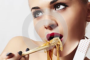 Beautiful woman eating chinese food. wok. close-up. red lips
