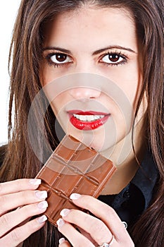 Beautiful woman eating chocolate