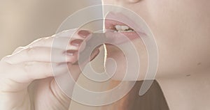 Beautiful Woman Eating Chocolate Bar Indulging with a Taste of Dessert a Close Up of Lipstick and Nails with Blurry Background wit