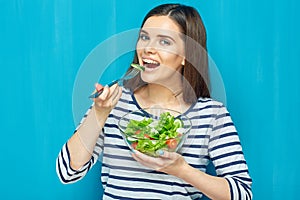 Beautiful woman eating healthy food green salad.