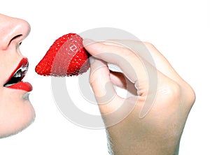 Beautiful woman eating a strawberry