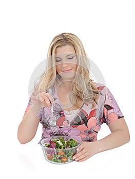 Beautiful woman eating vegetable salad