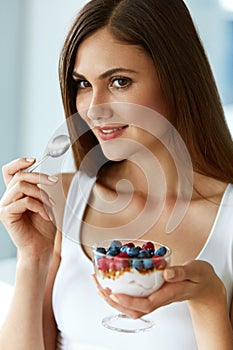 Beautiful Woman Eating Yogurt, Berries And Cereal. Healthy Diet