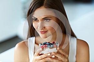 Beautiful Woman Eating Yogurt, Berries And Cereal. Healthy Diet