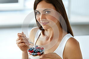 Beautiful Woman Eating Yogurt, Berries And Cereal. Healthy Diet