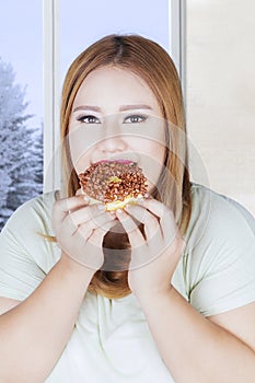 Beautiful woman eats donut