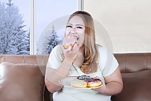 Beautiful woman eats donuts